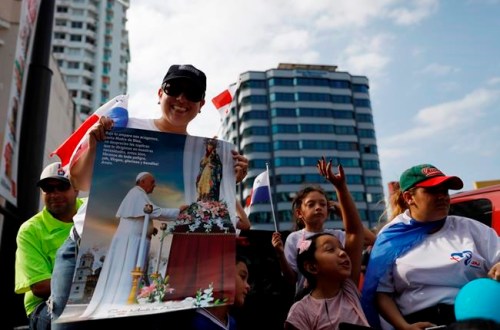 Panamanians wait by the roadside for Pope Francis to drive past, in Panama City, Wednesday, Jan. 23, 2019. Pope Francis is in Panama to attend World Youth Day, the church's once-every-three-year pep rally that aims to invigorate the next generation of Catholics in their faith. (AP Photo/Rebecca Blackwell)
