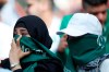 FILE - In this Thursday, June 14, 2018 filer, Saudi women sit in the stands ahead of the group A match between Russia and Saudi Arabia which opens the 2018 soccer World Cup at the Luzhniki stadium in Moscow, Russia. Facing increasing criticism by government members over the decision to play the Italian Super Cup in Saudi Arabia, Serie A's president is hailing the match as a 