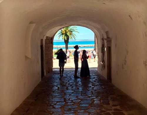 In this June, 27, 2018 photo, tourists walk through a tunnel at the medieval-area Castle of Lagos in Lagos, Portugal. Lagos, a striking Portuguese beach town of charming coastlines and slightly sandstone cliffs, is the birthplace of the African slave trade in Europe. A museum dedicated to slavery is helping this enclave in the heart of southern Portugal's Algarve region come to terms with its history. (AP Photo/Russell Contreras)