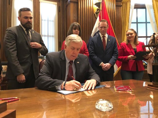 Missouri Gov. Mike Parson signs one of the nation's most restrictive abortion bills, banning the procedure on or beyond eight weeks of pregnancy, Friday, May 24, 2019 in Jefferson City, Mo. (AP Photo by Summer Balentine)