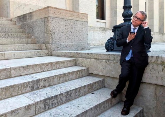Ohio Gov. Mike DeWine speaks on the cellphone with GM CEO Mary Barra, Wednesday, May 8, 2019, at the Ohio Statehouse in Columbus, about the company's plans to sell its shuttered factory in Lordstown, Ohio, to a company that builds electric trucks. DeWine, a Republican, said he wanted to hear more details about the plan, including the reaction of the UAW, but said the potential project was better than the plant sitting idle. (AP Photo/Andrew Welsh-Huggins)