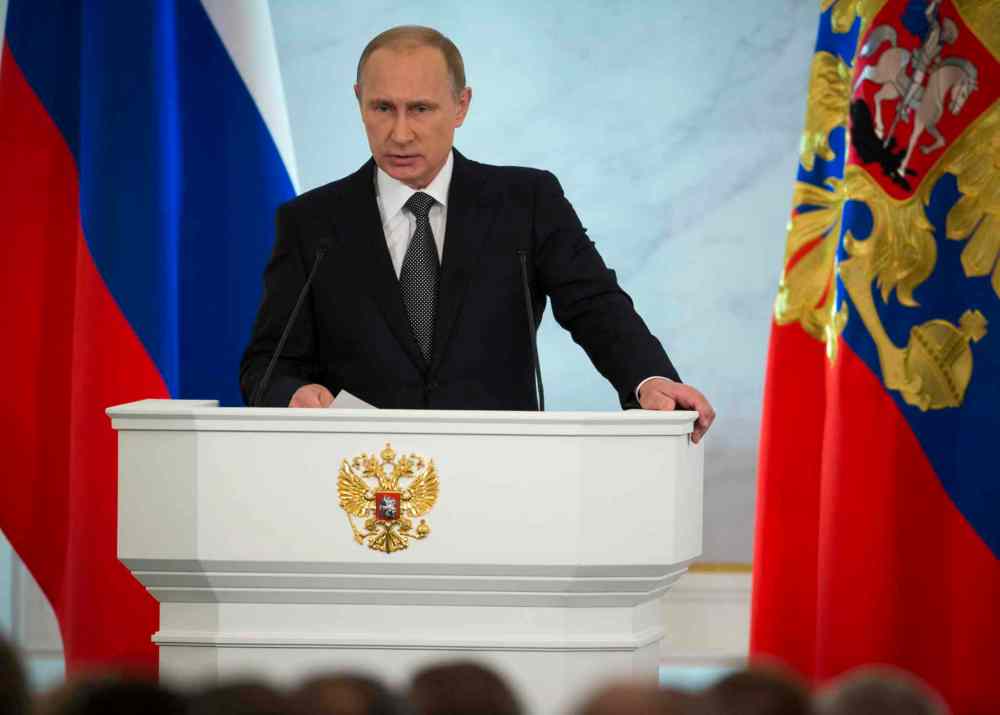 Pavel Golovkin / The Associated Press
Russian President Vladimir Putin gives his annual state of the nation address in the Kremlin in Moscow, Russia, on Thursday. Russian President Vladimir Putin has defended the Kremlin's aggressive foreign policy, saying the actions are necessary for his country's survival.
