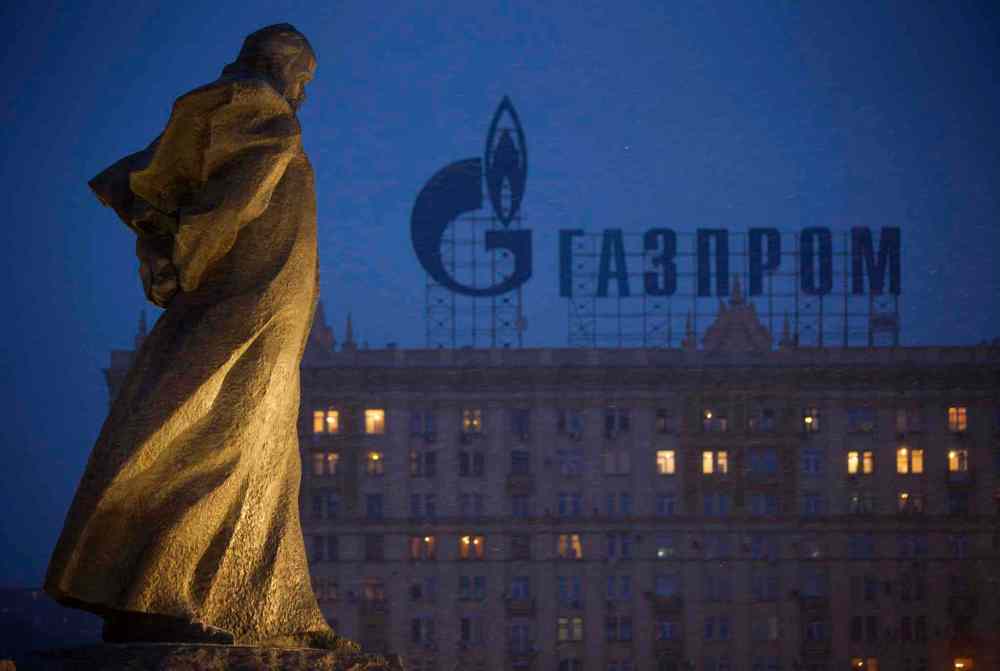 Alexander Zemlianichenko / The Associated Press
A monument to Ukrainian poet and writer Taras Shevchenko is silhouetted against an apartment building with a sign advertising Russia's natural gas giant Gazprom, in Moscow, Russia, Tuesday, March 4, 2014. Russia's state-controlled natural gas giant Gazprom said Tuesday it will cancel a price discount on gas it sells to Ukraine. Russia had offered the discount in December as part of Russian help for Ukraine. Gazprom also said Ukraine owes it $1.5 billion.