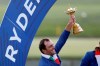 FILE - In this file photo taken in Saint Quentin-en-Yvelines, outside Paris, France, on Sept. 30, 2018, Italy's Francesco Molinari holds up the trophy after European team won the 2018 Ryder Cup golf tournament. Molinari is a major champion, a Ryder Cup hero and the poster boy of this week’s Italian Open. His achievements have helped boost golf’s popularity as the country prepares to host the 2022 Ryder Cup on Rome’s outskirts _ an idea that would have been unthinkable two decades ago. (AP Photo/Alastair Grant)