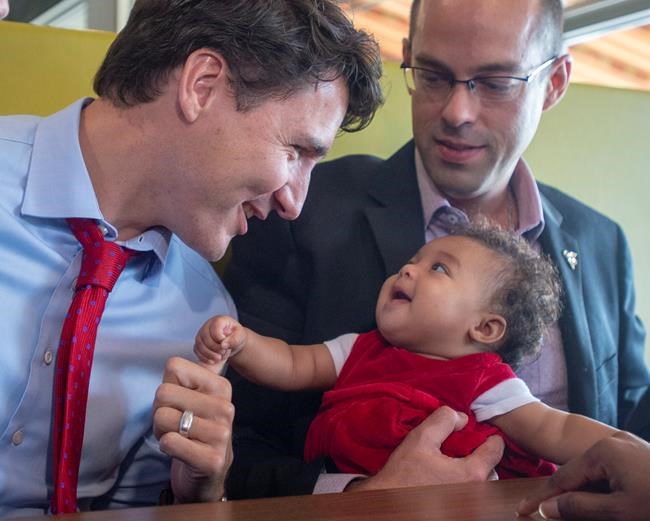 Liberal leader Justin Trudeau greets a young patron while campaigning at a restaurant Friday, October 4, 2019 in Quebec City.THE CANADIAN PRESS/Ryan Remiorz