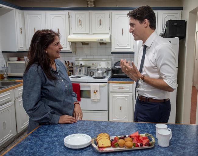Liberal leader Justin Trudeau chats with Bindy Gill before making a home retrofit announcement while campaigning in Delta, B.C. Wednesday, September 25, 2019 THE CANADIAN PRESS/Ryan Remiorz