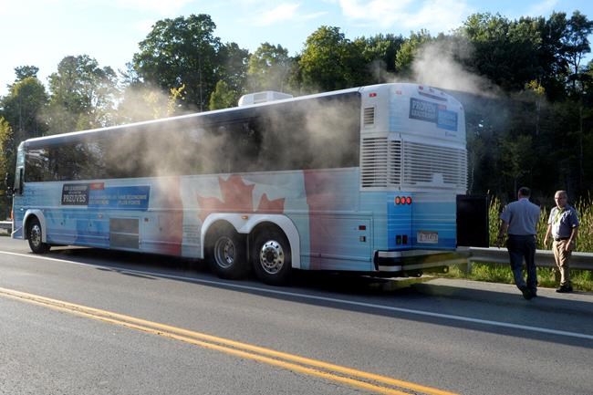 Smoke and steam surround the media contingent of the Conservative Party's campaign convoy following a radiator hose mishap on the road, on Monday, Sept. 21, 2015. THE CANADIAN PRESS/Ryan Remiorz