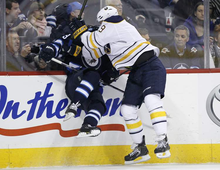 JOHN WOODS / WINNIPEG FREE PRESS
Winnipeg Jets defenceman Tobias Enstrom gets smashed into the boards by Buffalo Sabres enforcer Steve Ott during first-period NHL action at the MTS Centre in Winnipeg Tuesday.