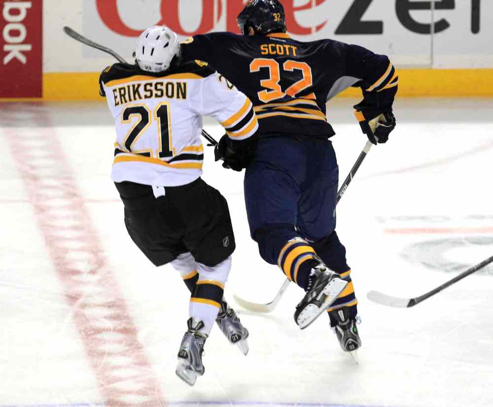 Harry Scull Jr. / THE CANADIAN PRESS
Buffalo Sabres John Scott (32) checks Boston Bruins Loui Eriksson (21) during third period action at the First Niagara Center in Buffalo on Wednesday, Oct. 2. Scott has been suspended indefinitely by the NHL pending a disciplinary hearing for a blindside hit to the head that levelled Eriksson.