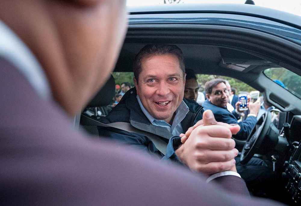 THE CANADIAN PRESS/Paul Chiasson
Conservative Leader Andrew Scheer shakes hands with a supporter while at a campaign stop in Brampton, Ont. on Friday.