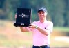 Justin Thomas of the United States poses with his trophy after winning the CJ Cup PGA golf tournament at Nine Bridges on Jeju Island, South Korea, Sunday, Oct. 20, 2019. (Park Ji-ho/Yonhap via AP)