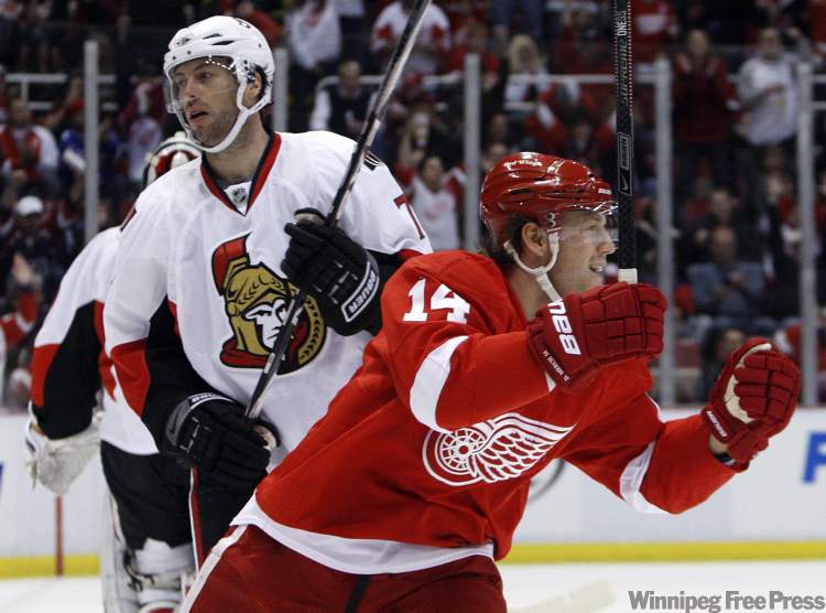 Carlos Osorio / The Associated Press Archives
In this file photo, defenceman Derek Meech (14) celebrates in front of Ottawa Senators centre Matt Cullen on a goal by Red Wings centre Pavel Datsyuk (not shown) during first period of an NHL game Saturday, Feb. 13, 2010, in Detroit.