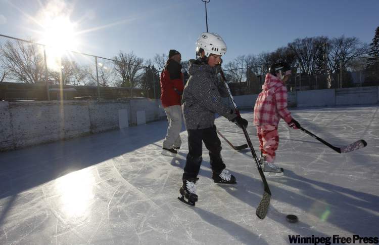 TREVOR HAGAN / WINNIPEG FREE PRESS
Marcel Gaborieau, left, was out skating with his grandchildren, Ty, 10 and McKenzie, 8.