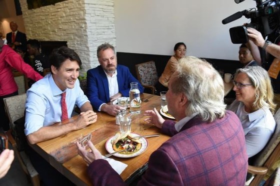 Liberal Leader Justin Trudeau speaks with people in a cafe as he mainstreets in downtown Winnipeg on Thursday, Sept.19, 2019. THE CANADIAN PRESS/Sean Kilpatrick