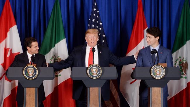 Prime Minister Justin Trudeau, right to left, participates in a signing ceremony for the new North American Free Trade Agreement with President of the United States Donald Trump and President of Mexico Enrique Pena Nieto in Buenos Aires, Argentina on Friday, Nov. 30, 2018. THE CANADIAN PRESS/Sean Kilpatrick