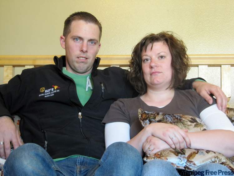 Jessie L. Bonner / The Associated Press
Ben and Amber Sessions pose for photos at their rental home in Rexburg, Idaho.