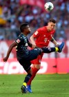 Cologne's Jhon Cordoba, left, and Bayern's Niklas Suele, right, challenge for the ball during the German Bundesliga soccer match between FC Bayern Munich and 1. FC Cologne in Munich, Germany, Saturday, Sept. 21, 2019. (AP Photo/Matthias Schrader)
