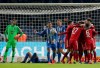 Hertha goalkeeper Rune Jarstein, left, reacts as Bayern's Kingsley Coman and his teammates, right, celebrate their side's 3rd goal during a German Soccer Cup round of sixteen match between Hertha BSC Berlin and FC Bayern Munich in Berlin, Germany, Wednesday, Feb. 6, 2019. (AP Photo/Michael Sohn)