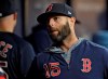 Boston Red Sox's Dustin Pedroia talks to a teammate before a baseball game against the Tampa Bay Rays, Friday, April 19, 2019, in St. Petersburg, Fla. Pedroia was placed on the 10-day disabled list after re-injuring his knee. (AP Photo/Chris O'Meara)