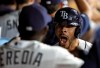 Tampa Bay Rays' Tommy Pham, right, celebrates in the dugout with Guillermo Heredia after hitting a grand slam off Arizona Diamondbacks starting pitcher Merrill Kelly during the second inning of a baseball game Monday, May 6, 2019, in St. Petersburg, Fla. (AP Photo/Chris O'Meara)