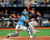 Tampa Bay Rays catcher Michael Perez, left, waits for the throw as Boston Red Sox's Steve Pearce scores on Xander Bogaerts' two-run single during the sixth inning of a baseball game Sunday, April 21, 2019, in St. Petersburg, Fla. (AP Photo/Steve Nesius)