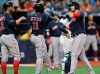 Boston Red Sox's Xanader Bogaerts, left, and Rafael Devers (11) celebrate with J.D. Martinez, right, after Martinez hit a three-run home run off Tampa Bay Rays starter Jalen Beeks during the third inning of a baseball game Monday, July 22, 2019, in St. Petersburg, Fla. (AP Photo/Steve Nesius)