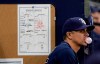 Tampa Bay Rays major league field coordinator Paul Hoover stands near the line up card during the bottom of the eighth inning of a baseball game against the Boston Red Sox Wednesday, July 24, 2019, in St. Petersburg, Fla. (AP Photo/Chris O'Meara)