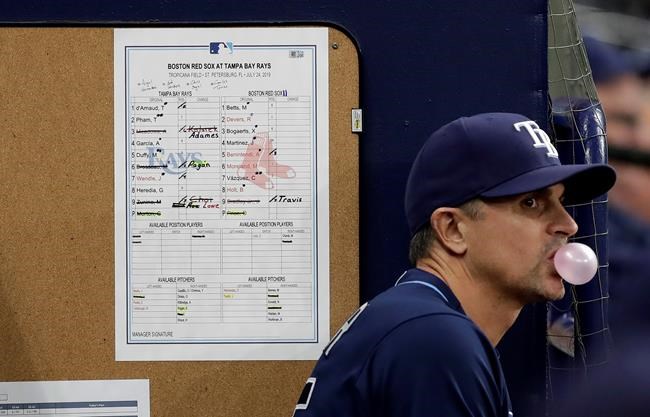 Tampa Bay Rays major league field coordinator Paul Hoover stands near the line up card during the bottom of the eighth inning of a baseball game against the Boston Red Sox Wednesday, July 24, 2019, in St. Petersburg, Fla. (AP Photo/Chris O'Meara)