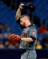 Arizona Diamondbacks starting pitcher Merrill Kelly wipes his forehead as he struggles against the Tampa Bay Rays during the second inning of a baseball game Monday, May 6, 2019, in St. Petersburg, Fla. (AP Photo/Chris O'Meara)