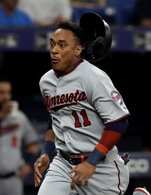 Minnesota Twins' Jorge Polanco loses his helmet as he scores on a single by Willians Astudillo off Tampa Bay Rays relief pitcher Jalen Beeks during the fifth inning of a baseball game Friday, May 31, 2019, in St. Petersburg, Fla. (AP Photo/Chris O'Meara)