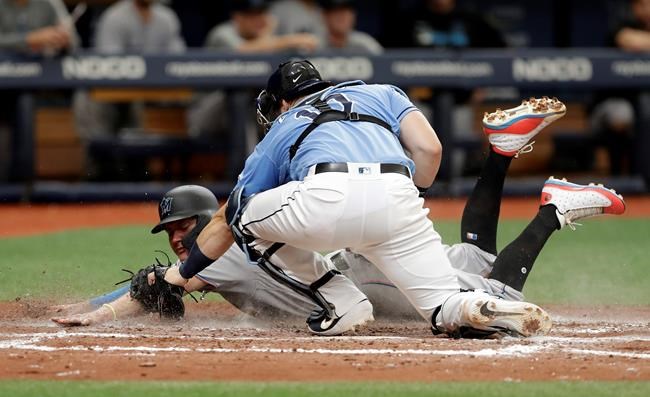 Tampa Bay Rays catcher Mike Zunino (10) tags out Miami Marlins' Miguel Rojas who was attempting to steal home plate during the sixth inning of a baseball game Sunday, Aug. 4, 2019, in St. Petersburg, Fla. (AP Photo/Chris O'Meara)