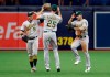 Oakland Athletics center fielder Ramon Laureano (22), right fielder Stephen Piscotty (25) and left fielder Robbie Grossman (8) celebrate after the team defeated the Tampa Bay Rays during a baseball game Wednesday, June 12, 2019, in St. Petersburg, Fla. Oakland defeated Tampa Bay 6-2. (AP Photo/Chris O'Meara)