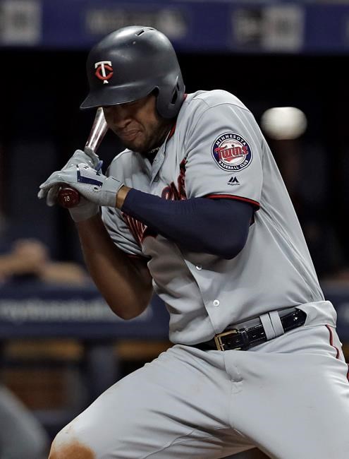 Minnesota Twins' Jonathan Schoop gets hit with a pitch from Tampa Bay Rays reliever Diego Castillo during the ninth inning of a baseball game Friday, May 31, 2019, in St. Petersburg, Fla. (AP Photo/Chris O'Meara)