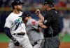 Boston Red Sox first baseman Steve Pearce, center, tags out Tampa Bay Rays' Tommy Pham, left, at first on a pickoff play during the ninth inning of a baseball game Saturday, April 20, 2019, in St. Petersburg, Fla. Making the call is umpire Rob Drake. (AP Photo/Chris O'Meara)