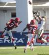 DEAN BICKNELL / Postmedia News
Winnipeg Blue Bombers' Clarence Denmark goes up to catch a pass in front of Calgary Stampeders' Demetrice Morley (left) and Keon Raymond at McMahon Stadium in Calgary Saturday.