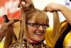 KEN GIGLIOTTI / WINNIPEG  FREE PRESS
Sandra Bellingham honours the memory of her husband WPS Staff Sgt. Wayne Bellingham who died of cancer 11 years ago by getting her head shaved this morning at Robert H. Smith School. Over $7,000 was raised for CancerCare Manitoba at the community breakfast.