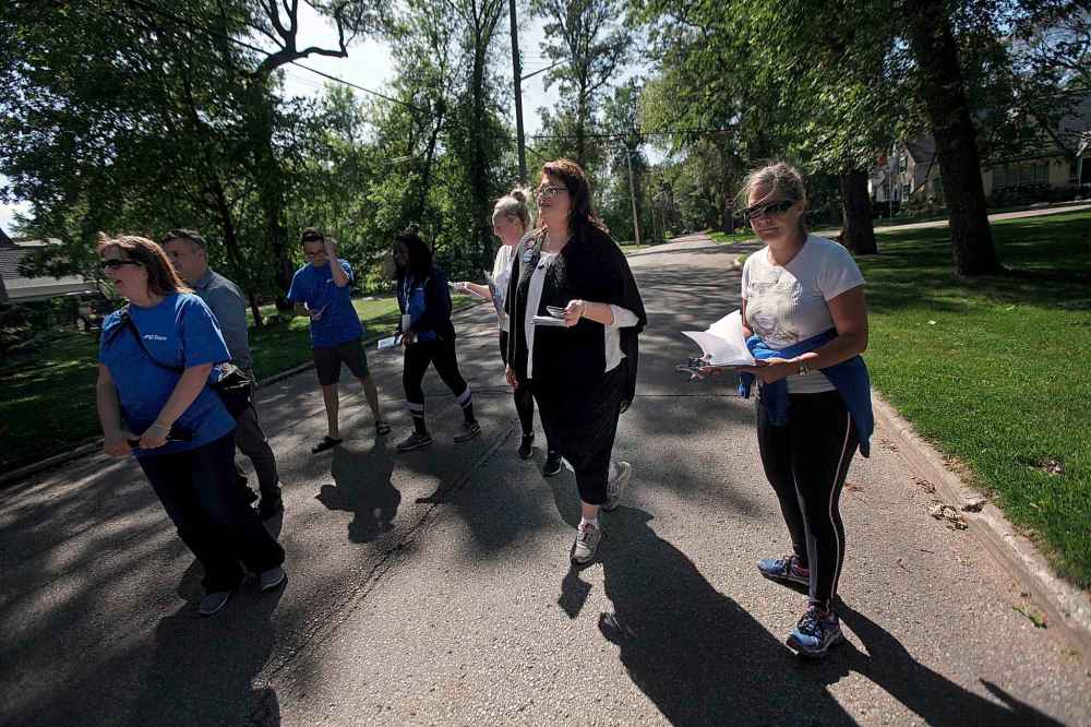 PHIL HOSSACK / WINNIPEG FREE PRESS
Incumbent St Vital MLA and Progressive Conservative candidate Colleen Mayer pounds the pavement along Kingston Row Thursday with members of her team.