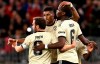 Manchester United's Marcus Rashford, centre, is congratulated by teammates Juan Mata, left, and Paul Pogba after scoring a goal against the Perth Glory during their friendly soccer match in Perth, Australia, Saturday, July 13, 2019. (Richard Wainwright/AAP Image via AP)
