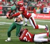 DEAN BICKNELL / CANWEST NEWS SERVICE ARCHIVES
Roughriders’ Chris Getzlaf (89) is tackled by Stampeders John Eubanks and Brandon Browner last Sunday. The game ended in a tie, but the clubs clash again this season.
