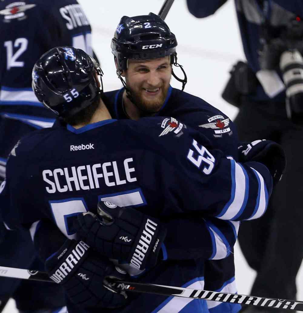 Trevor Hagan / Winnipeg Free Press
Winnipeg Jets' Mark Scheifele (55) and Adam Pardy (2) celebrate after the teams victory against the Calgary Flames.