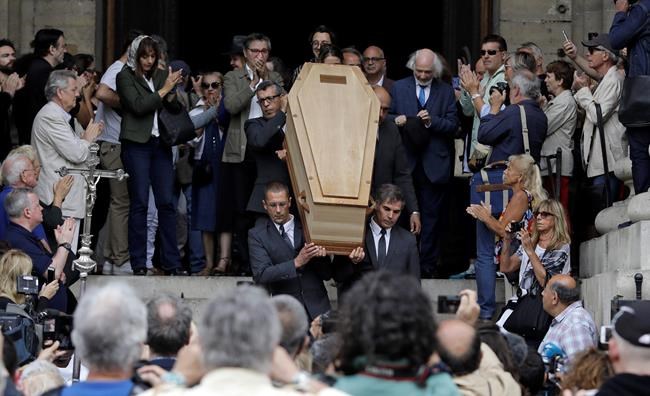 The coffin of French film director Jean Pierre Mocky is carried down the steps of Saint Sulpice church in Paris following his funeral, Monday, Aug. 12, 2019. (AP Photo/Lewis Joly)
