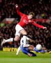 FILE - In this Saturday Jan. 27, 2007 file photo Manchester United's Ole Gunnar Solskjaer, left, has a shot on goal past Portsmouth's Sol Campbell during their FA Cup fourth round soccer match at Old Trafford Stadium, Manchester, England. Manchester United announced Wednesday Dec. 19, 2018, they have hired Ole Gunnar Solskjaer as its manager until the end of the season, bringing the Norwegian back to the club 20 seasons after he scored its winning goal in the Champions League final. (AP Photo/Scott Heppell, File)