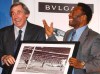 FILE - In this Thursday March 4, 2004 file photo Brazilian soccer legend Pele, right, presents former England goalkeeper Gordon Banks with a photograph showing Banks saving a header from Pele in the 1970 World Cup, at a press conference in London, to mark FIFA's 100 year anniversary. English soccer club Stoke said Tuesday Feb. 12, 2019 that World Cup-winning England goalkeeper Gordon Banks has died at 81. (AP Photo/Max Nash, File)