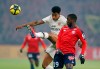 Lille's Nicolas Pepe looks on as PSG's Presnel Kimpembe clears the ball during the French League One soccer match between OSC Lille and Paris-Saint-Germain at Stade Pierre Mauroy in Lille, France, Sunday, April 14, 2019.(AP Photo/Michel Spingler)