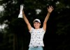 Japan's Hinako Shibuno reacts as she holds the trophy as she celebrates after winning the Women's British Open golf championship at Woburn Gold Club near near Milton Keynes, England, Sunday, Aug. 4, 2019. (AP Photo/Tim Ireland)