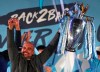 Manchester City coach Pep Guardiola holds the trophy as he celebrates with supporters at the Etihad Stadium in Manchester, England, Sunday May 12, 2019 the day they won the English Premier League title. Manchester City retained the Premier League trophy after coming from behind to beat Brighton 4-1 and see off Liverpool's relentless challenge on the final day of the season on Sunday. (AP Photo/Jon Super)
