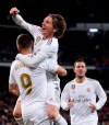 Real Madrid's Luka Modric celebrates with Karim Benzema after scoring his side's third goal during the Spanish La Liga soccer match between Real Madrid and Real Sociedad at the Bernabeu stadium in Madrid, Spain, Spain, Saturday, Nov. 23, 2019. (AP Photo/Manu Fernandez)