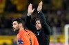Tottenham keeper Hugo Lloris and coach Mauricio Pochettino greet supporters after the Champions League round of 16, 2nd leg, soccer match between Borussia Dortmund and Tottenham Hotspur at the BVB stadium in Dortmund, Germany, Tuesday, March 5, 2019. (Bernd Thissen/dpa via AP)