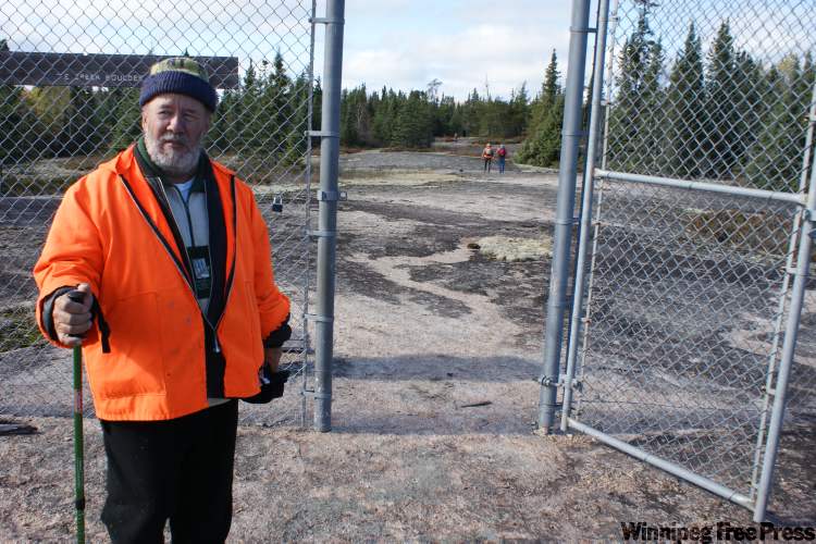 BILL REDEKOP / WINNIPEG FREE PRESS
Tour guide Ron Bell opens the convict-built fence that surrounds the petroforms.