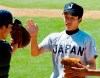 FILE - In this Sept. 4, 2006, file photo, Japan pitcher Yuki Saito, right, is congratulated by catcher Tesshin Sameshima after getting a double play to end the fifth inning of Game 3 of a baseball game against the U.S. at the 15th Goodwill Series in Los Angeles. Amateur baseball officials in Japan are debating the introduction of pitch limits aimed at preventing injuries to high school players. (AP Photo/Chris Pizzello, File)